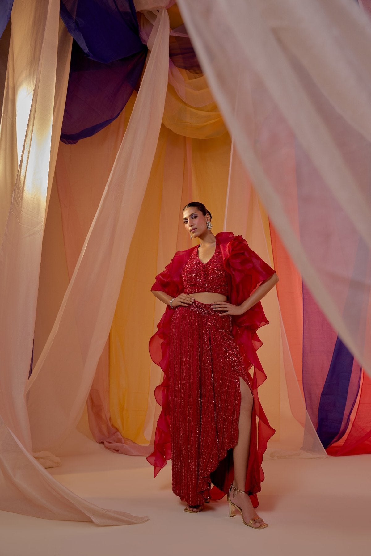 RUBY RED FULLY EMBROIDERED HALTER BLOUSE WITH DRAPE SKIRT AND RUFFLE ORGANZA CAPE
