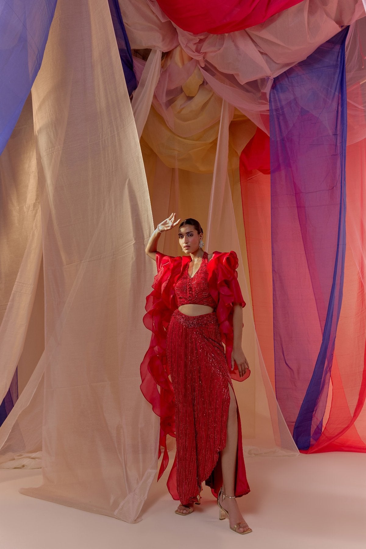 RUBY RED FULLY EMBROIDERED HALTER BLOUSE WITH DRAPE SKIRT AND RUFFLE ORGANZA CAPE