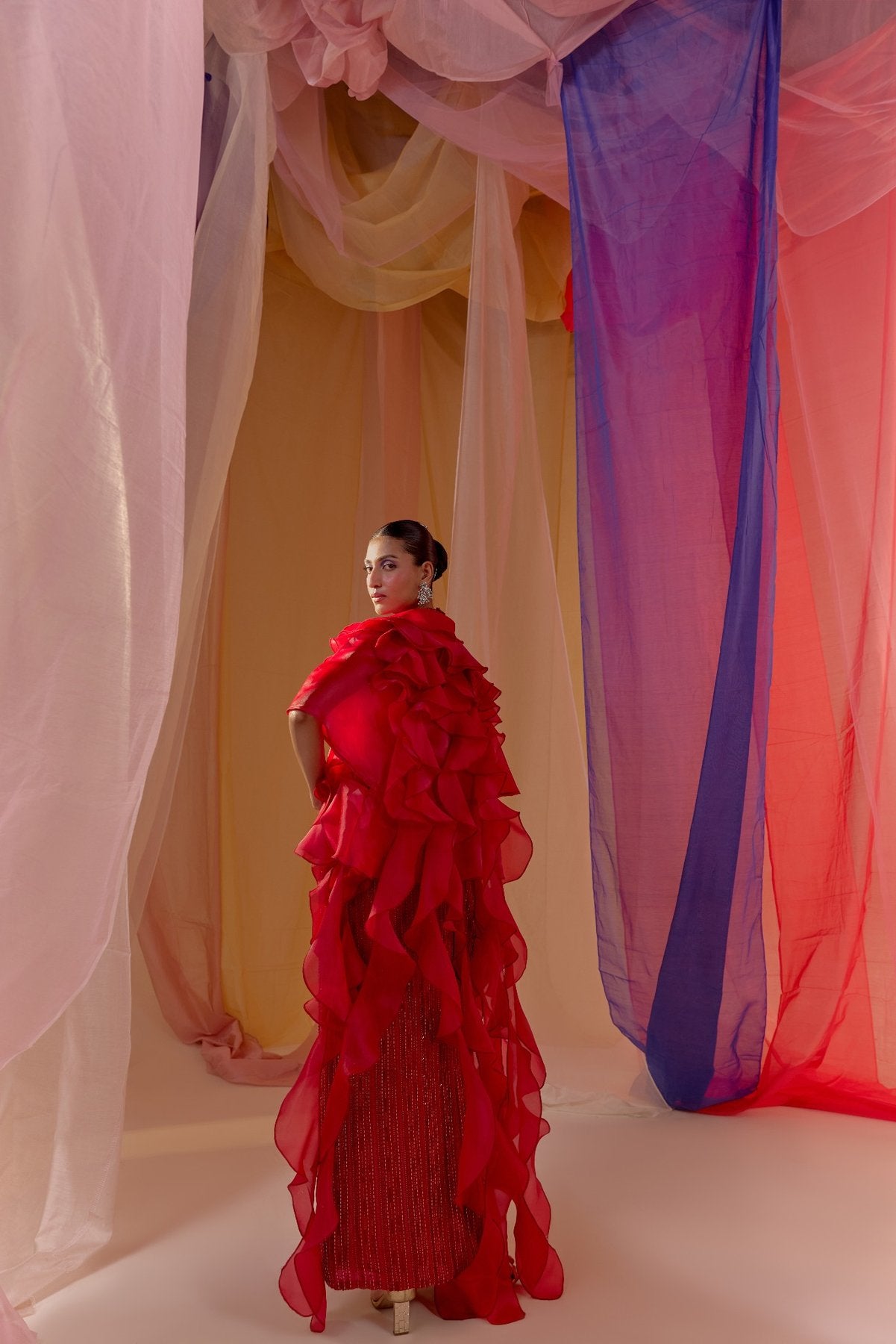 RUBY RED FULLY EMBROIDERED HALTER BLOUSE WITH DRAPE SKIRT AND RUFFLE ORGANZA CAPE