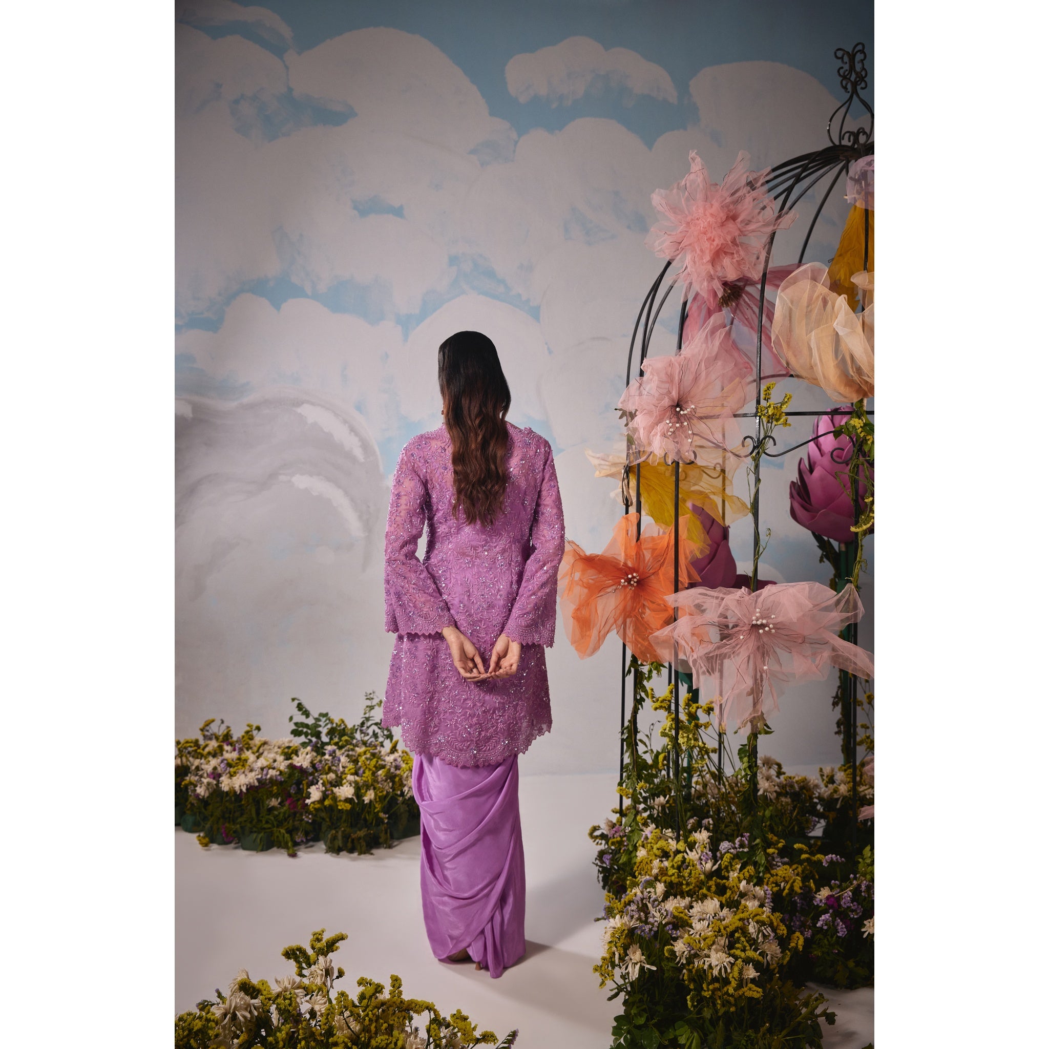 Lavender organza jacket with self dori embroidery paired with drape skirt and bustier