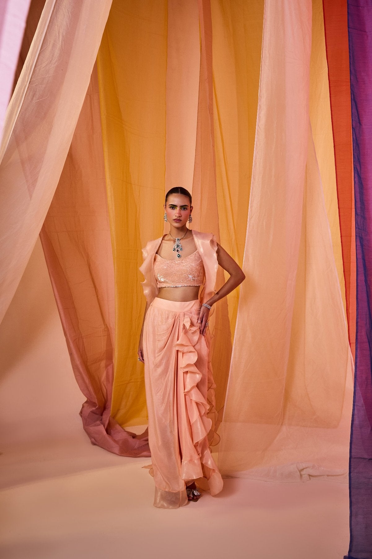 PEACH SEQUENCE EMBROIDERED BLOUSE WITH DRAPE SKIRT AND DRAMATIC RUFFLE CAPE
