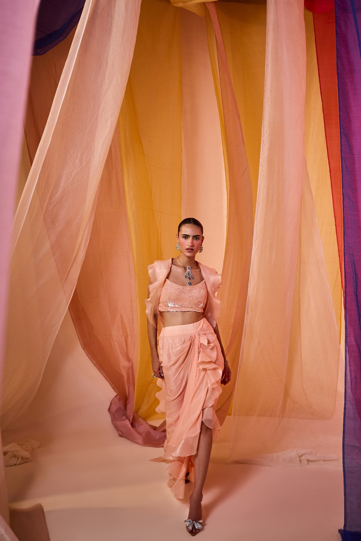 PEACH SEQUENCE EMBROIDERED BLOUSE WITH DRAPE SKIRT AND DRAMATIC RUFFLE CAPE
